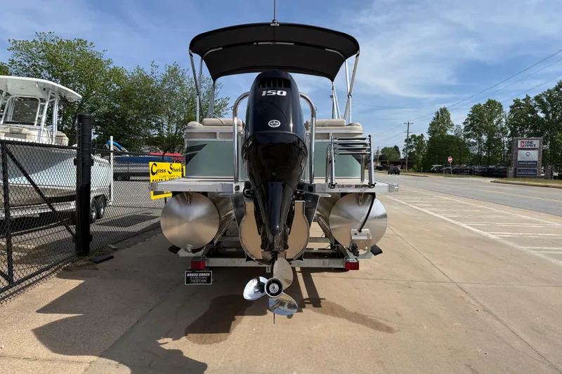 Slide: The Image of 2026 Avalon VENTURE QUAD LOUNGE pontoon boat with 150 HP engine, parked outdoors. - 59