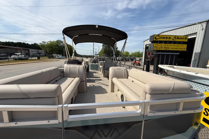 Slide: The Image of 2026 Avalon VENTURE QUAD LOUNGE pontoon boat with spacious seating and canopy, parked outdoors. - 62