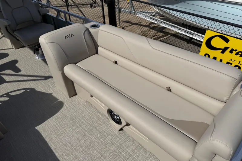 Slide: The Image of 2026 Avalon VENTURE QUAD LOUNGE boat interior with beige seating and cup holder. - 64