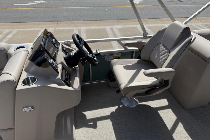Slide: The Image of 2026 Avalon VENTURE QUAD LOUNGE boat helm with steering wheel and comfortable captain's chair. - 67