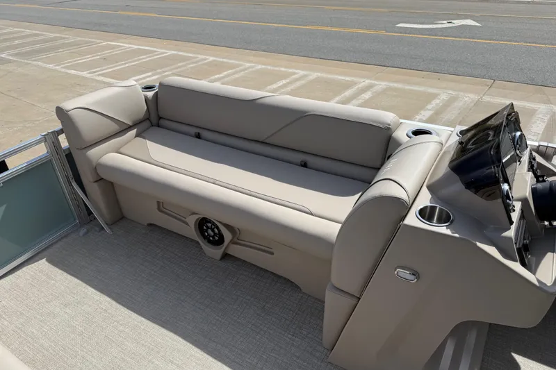 Slide: The Image of 2026 Avalon VENTURE QUAD LOUNGE boat interior with beige seating and modern dashboard. - 68