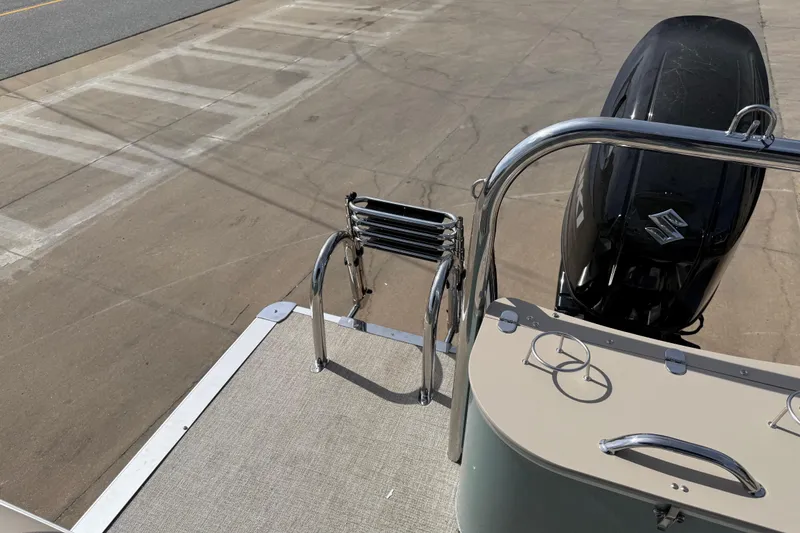 Slide: The Image of 2026 Avalon VENTURE QUAD LOUNGE boat with Suzuki outboard motor and boarding ladder. - 73