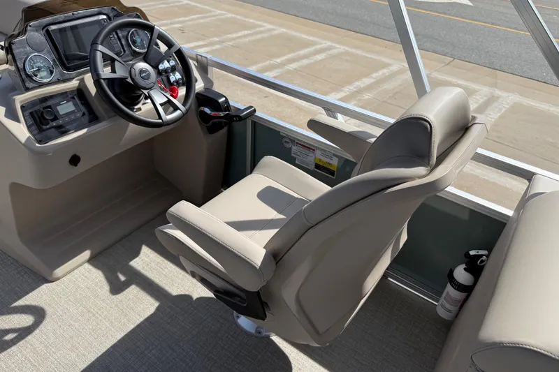 Slide: The Image of 2026 Avalon VENTURE QUAD LOUNGE boat interior with steering console and captain's chair. - 80