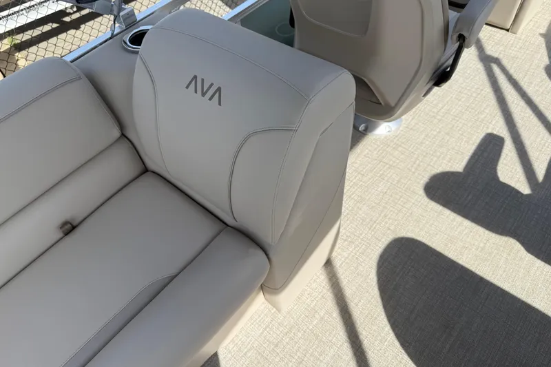 Slide: The Image of 2026 Avalon VENTURE QUAD LOUNGE boat interior with beige seating and cup holder. - 94