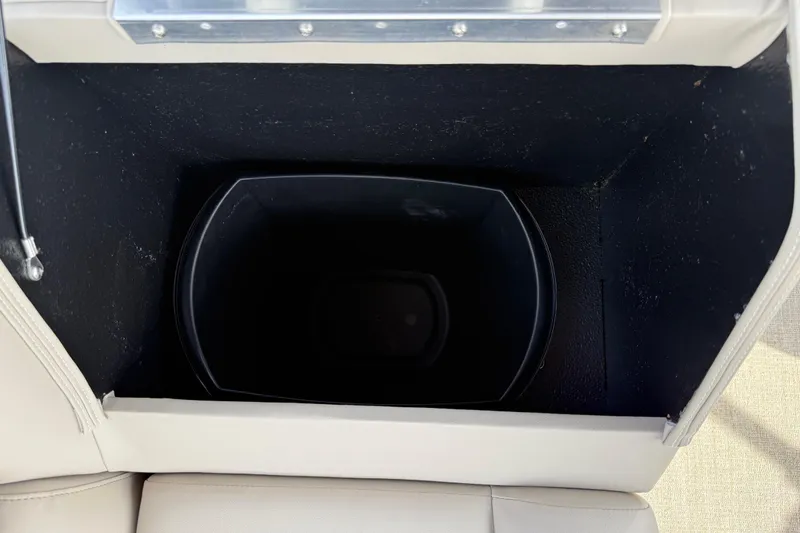 Slide: The Image of Storage compartment in 2026 Avalon VENTURE QUAD LOUNGE boat, featuring a black interior. - 95