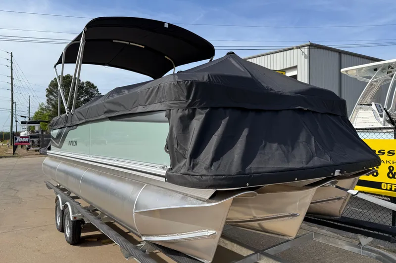 Slide: The Image of 2026 Avalon VENTURE QUAD LOUNGE pontoon boat with black cover on trailer. - 98