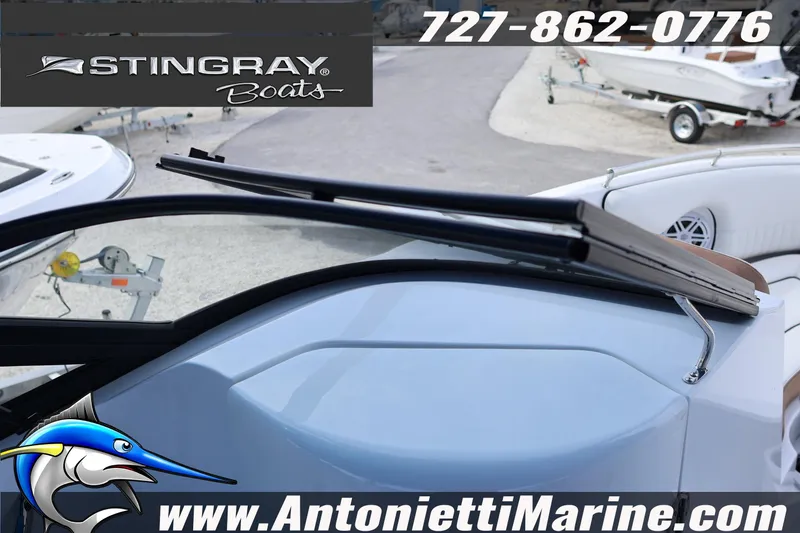 Slide: The Image of 2026 Stingray 211 DC boat interior with windshield detail at Antonietti Marine. - 15