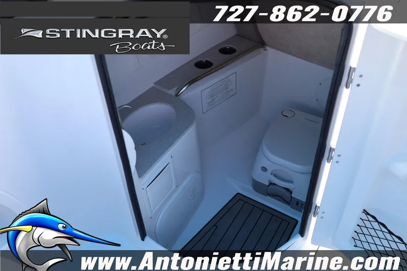 Slide: The Image of Interior of 2026 Stingray 211 DC boat featuring compact bathroom amenities. - 16