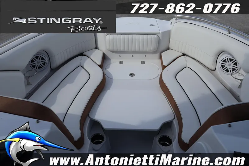Slide: The Image of Interior view of 2026 Stingray 211 DC boat with white seating and speakers. - 20