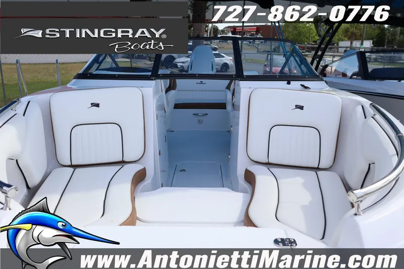 Slide: The Image of 2026 Stingray 211 DC boat interior with white seating, displayed by Antonietti Marine. - 3