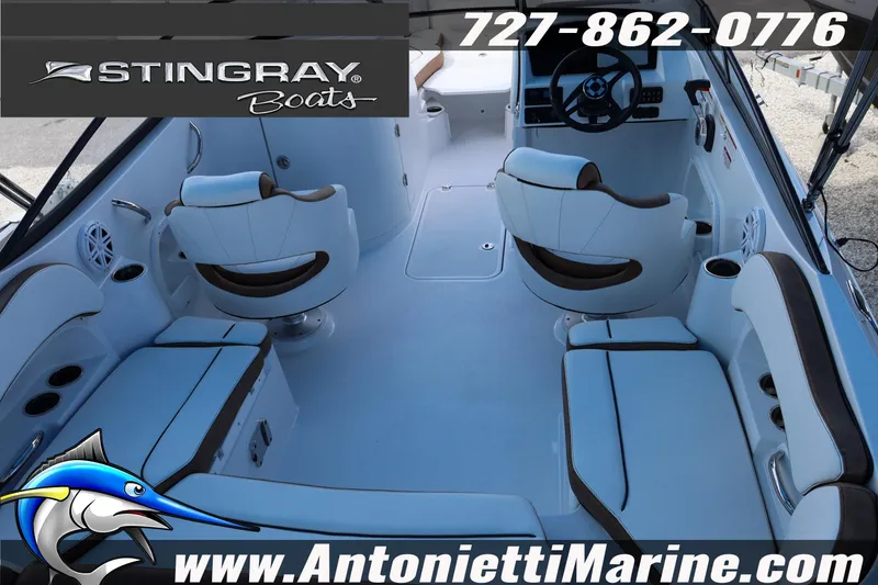 Slide: The Image of Interior view of 2026 Stingray 211 DC boat with seating and steering wheel. - 8