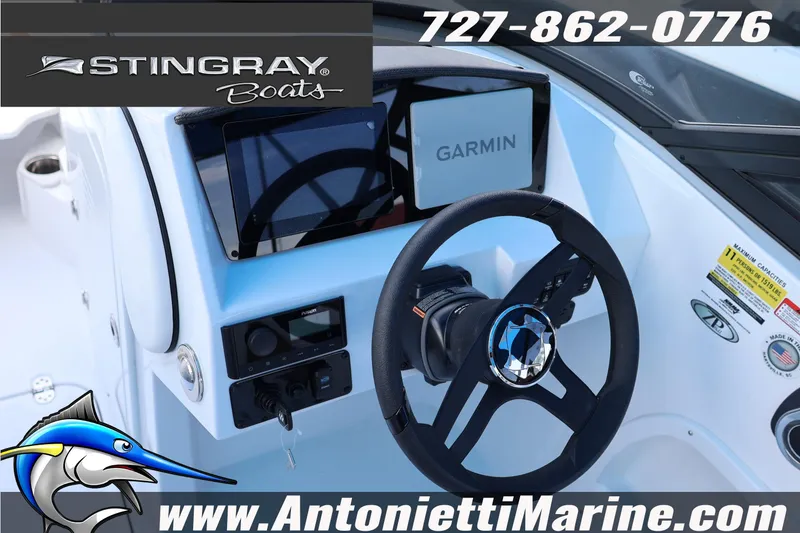 Slide: The Image of 2026 Stingray 211 DC boat dashboard with Garmin navigation system and steering wheel. - 9