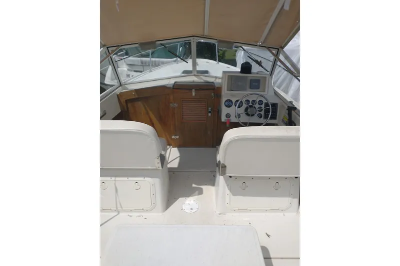 Slide: The Image of 2004 Limestone 24 Runabout boat interior with steering wheel and dashboard controls. - 5