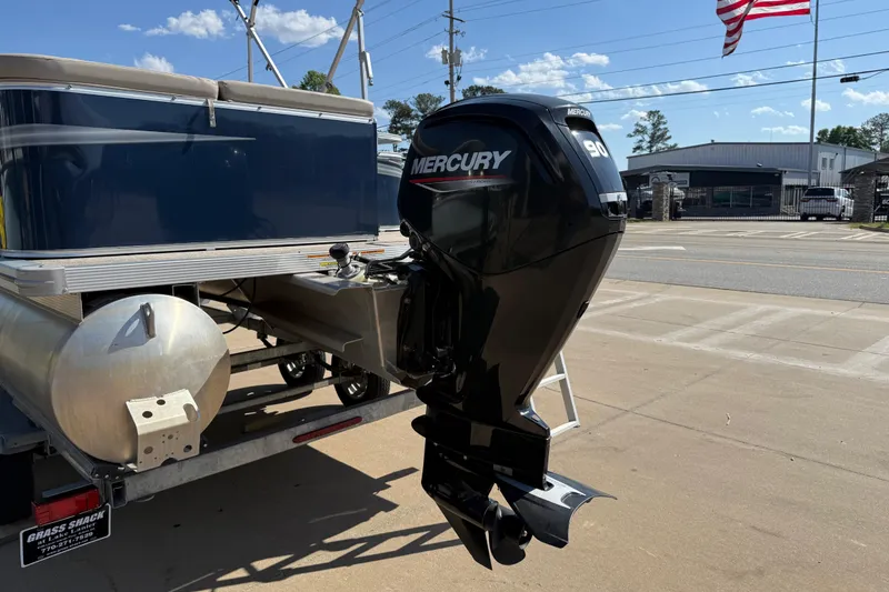 Slide: The Image of 2022 Tahoe Pontoon Sport Cruise with Mercury 90 outboard motor on trailer. - 12