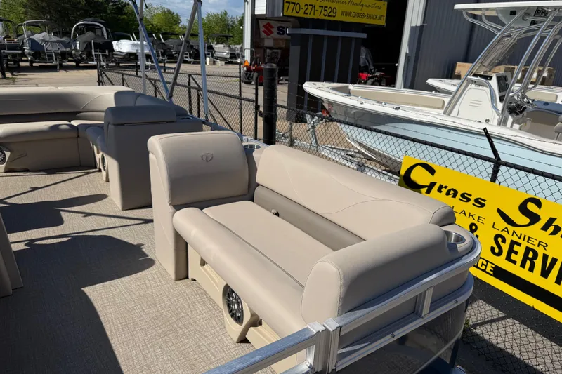 Slide: The Image of 2022 Tahoe Pontoon Sport Cruise boat with beige seating, displayed outdoors. - 14