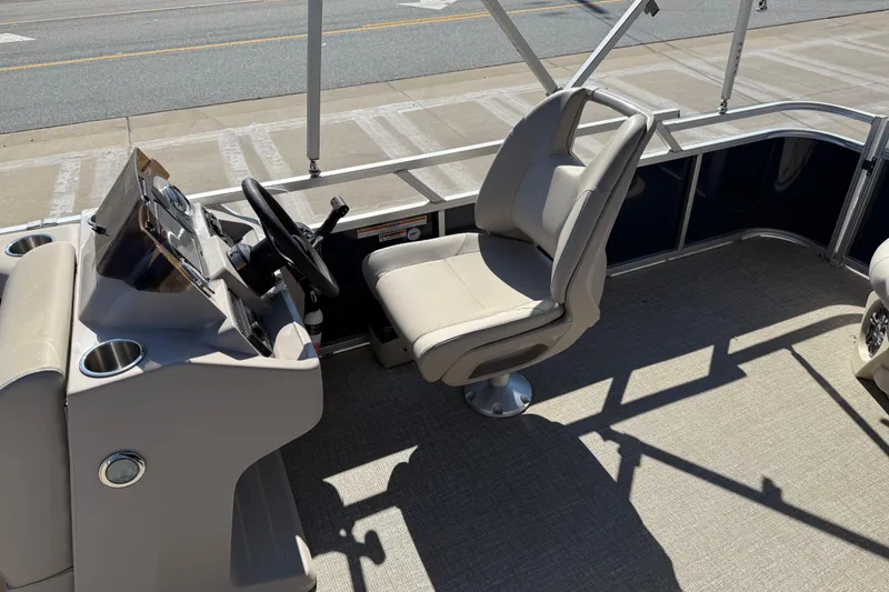 Slide: The Image of 2022 Tahoe Pontoon Sport Cruise interior with captain's chair and steering console. - 19