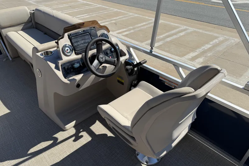 Slide: The Image of 2022 Tahoe Pontoon Sport Cruise interior with steering console and seating. - 20