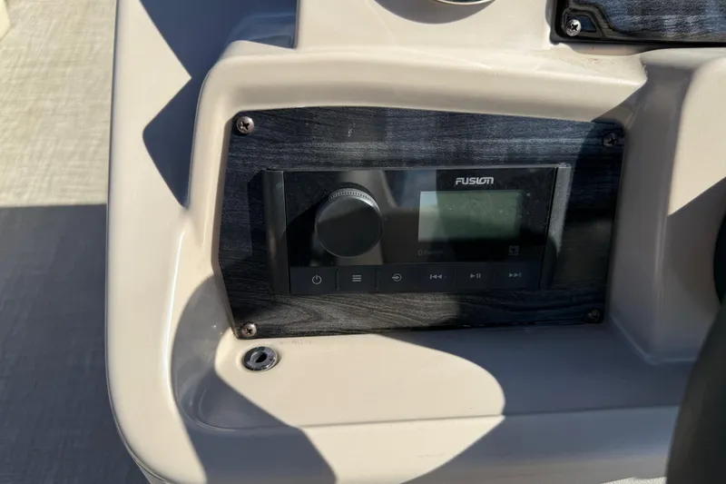 Slide: The Image of 2022 Tahoe Pontoon Sport Cruise dashboard with Fusion audio system. - 23