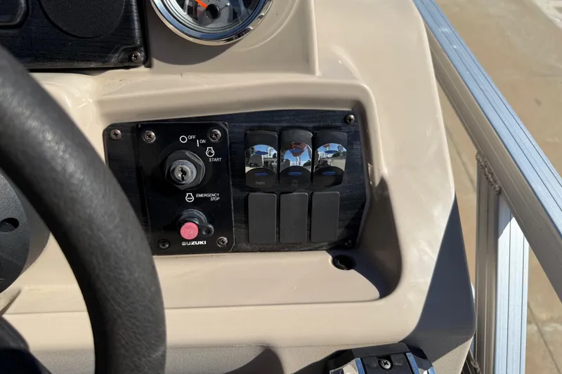 Slide: The Image of Control panel of 2022 Tahoe Pontoon Sport Cruise with ignition and switches. - 24