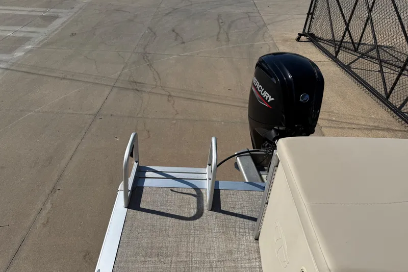 Slide: The Image of 2022 Tahoe Pontoon Sport Cruise with Mercury outboard motor on a concrete surface. - 27