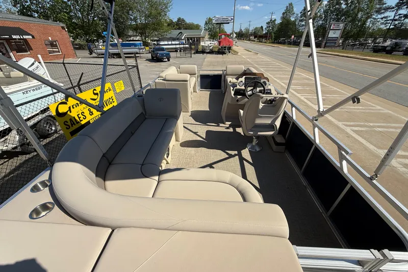 Slide: The Image of 2022 Tahoe Pontoon Sport Cruise boat with beige seating, parked at a dealership. - 30