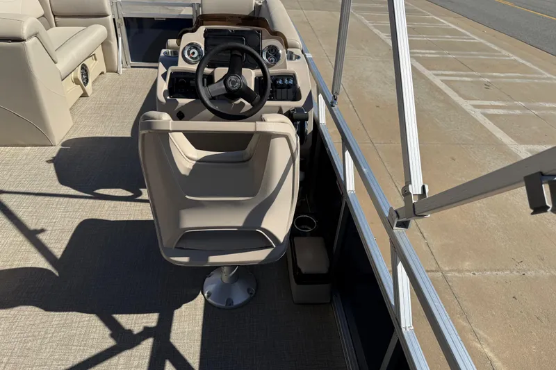 Slide: The Image of 2022 Tahoe Pontoon Sport Cruise boat interior with steering wheel and seating. - 32