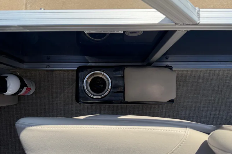 Slide: The Image of 2022 Tahoe Pontoon Sport Cruise interior with cup holder and fire extinguisher. - 34