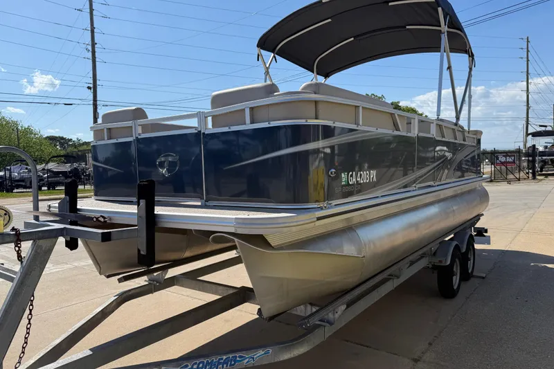 Slide: The Image of 2022 Tahoe Pontoon Sport Cruise on trailer, parked outdoors under sunny sky. - 9