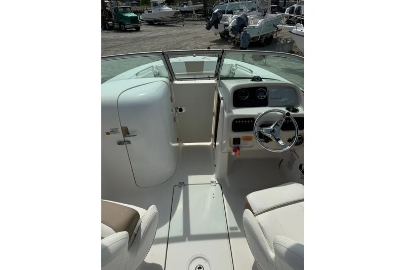 Slide: The Image of 2019 Robalo R207 Dual Console boat interior with steering wheel and seating. - 12