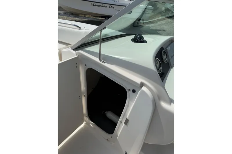 Slide: The Image of 2019 Robalo R207 Dual Console boat interior with open storage compartment. - 13