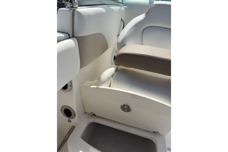Slide: The Image of 2019 Robalo R207 Dual Console interior seating and storage compartment. - 18
