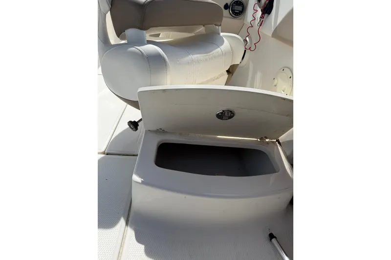 Slide: The Image of 2019 Robalo R207 Dual Console boat seat with open storage compartment. - 19