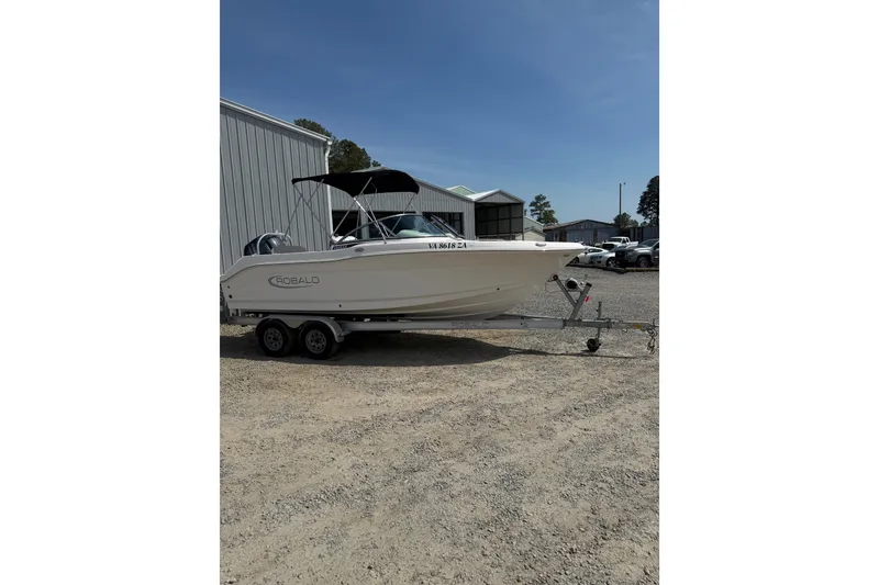 Slide: The Image of 2019 Robalo R207 Dual Console boat on trailer, parked outdoors. - 23