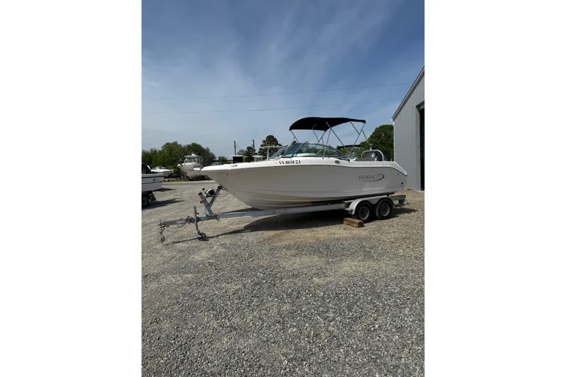 Slide: The Image of 2019 Robalo R207 Dual Console boat on trailer, parked outdoors. - 26