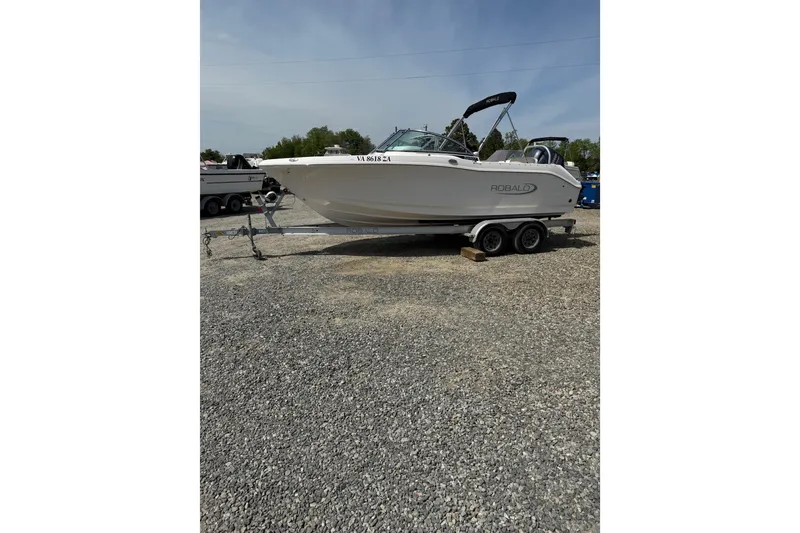 Slide: The Image of 2019 Robalo R207 Dual Console boat on trailer in outdoor setting. - 28