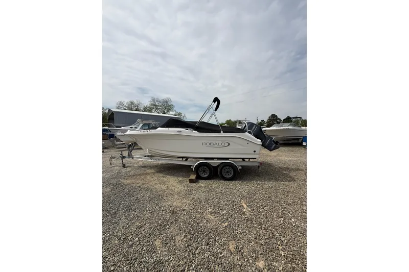 Slide: The Image of 2019 Robalo R207 Dual Console boat on trailer, parked outdoors. - 3