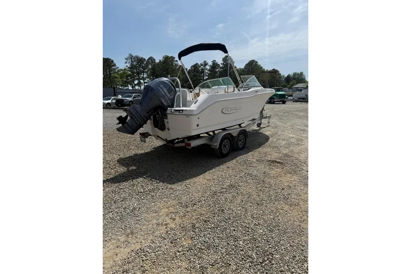 Slide: The Image of 2019 Robalo R207 Dual Console boat on trailer in outdoor setting. - 30