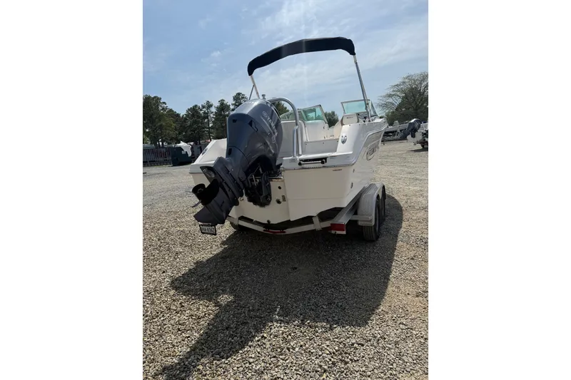 Slide: The Image of 2019 Robalo R207 Dual Console boat on a trailer, rear view. - 32
