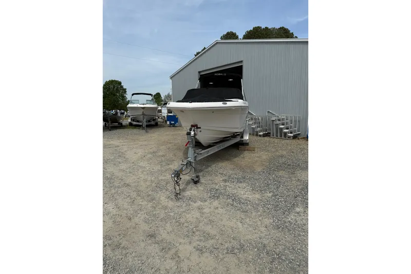 Slide: The Image of 2019 Robalo R207 Dual Console boat on trailer outside a storage facility. - 6