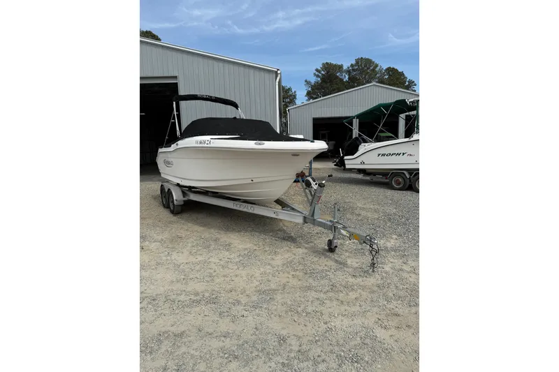 Slide: The Image of 2019 Robalo R207 Dual Console boat on trailer, parked outside a storage facility. - 7