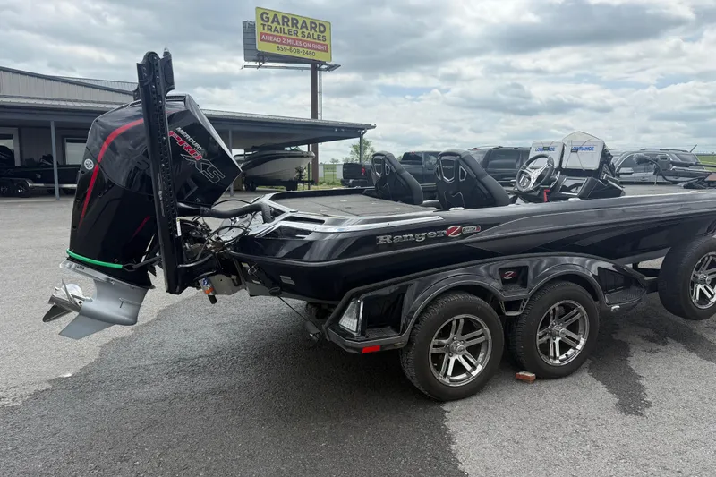 Slide: The Image of 2024 Ranger Z520R boat with powerful outboard motor, parked at dealership. - 5