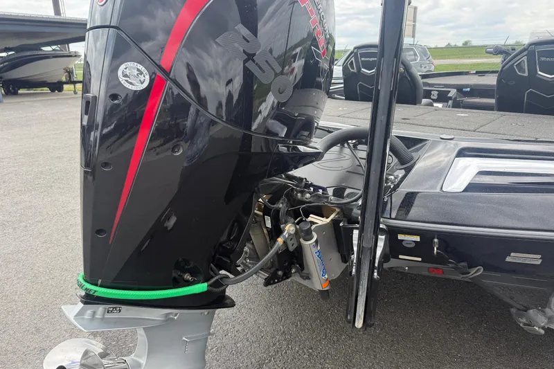 Slide: The Image of 2024 Ranger Z520R boat with powerful outboard motor, parked on asphalt. - 6