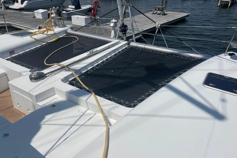 Slide: The Image of 2016 Lagoon 450 F catamaran docked, featuring deck and netting. - 24