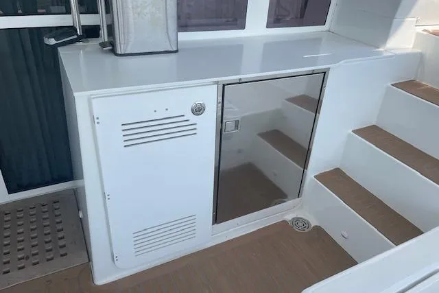 Slide: The Image of Interior of 2016 Lagoon 450 F yacht showing a sleek kitchenette and stairs. - 28