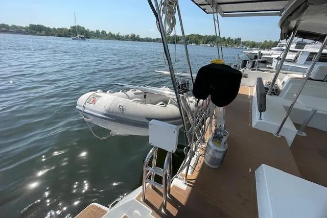 Slide: The Image of 2016 Lagoon 450 F catamaran with dinghy on calm water. - 30