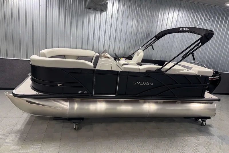 The Image of 2026 Sylvan Mirage 8520 Cruise PTS Tritoon in showroom, sleek design, luxury seating. - 0