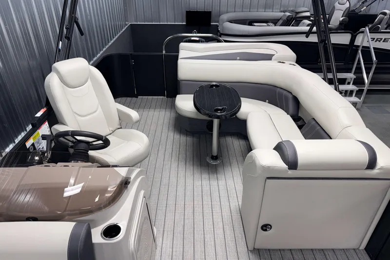 Slide: The Image of Luxurious interior of 2026 Sylvan Mirage 8520 Cruise PTS Tritoon with plush seating and steering console. - 12