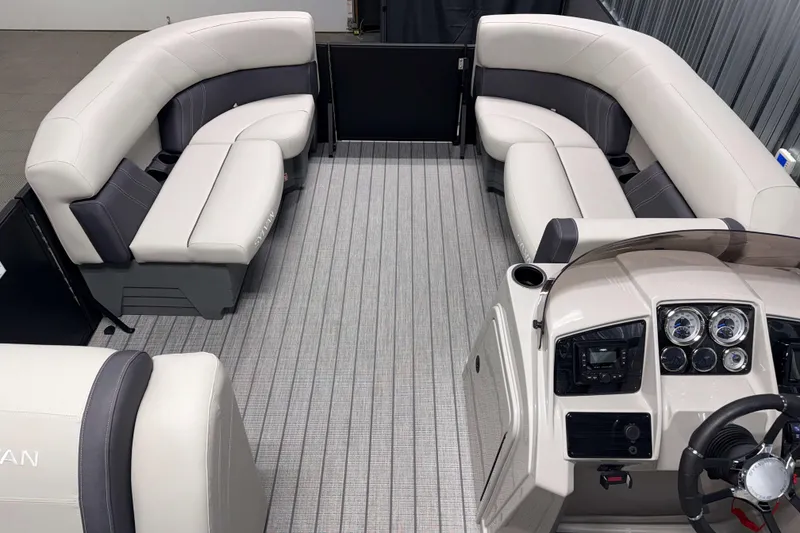 Slide: The Image of Interior of 2026 Sylvan Mirage 8520 Cruise PTS Tritoon with plush seating and modern dashboard. - 13