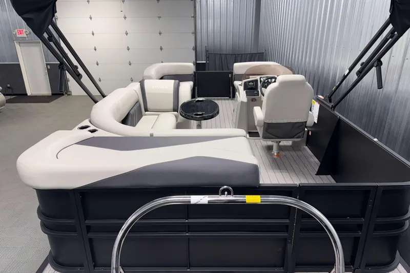 Slide: The Image of 2026 Sylvan Mirage 8520 Cruise PTS Tritoon interior with modern seating and steering console. - 2