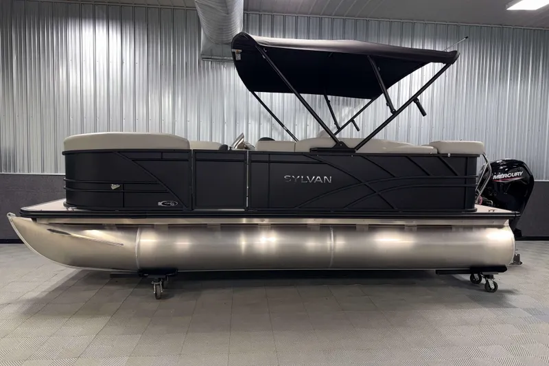 Slide: The Image of 2026 Sylvan Mirage 8520 Cruise PTS Tritoon in showroom, side view with canopy. - 21
